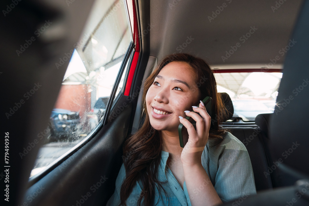 Thoughtful woman talking on smart phone sitting in car Thoughtful woman talking on smart phone sitting in car