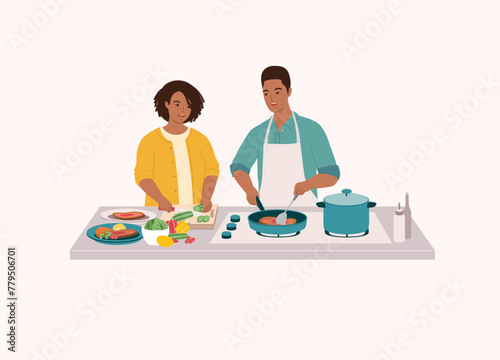 Black Couple Preparing Food Together In The Kitchen. Smiling Black Wife Cutting Cucumber With Knife. Husband In Apron Cooking Steak With Frying Pan. Half Length.
