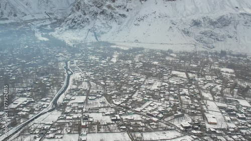 Panning drone view of snow covered crowded Skardu city, Pakistan. photo