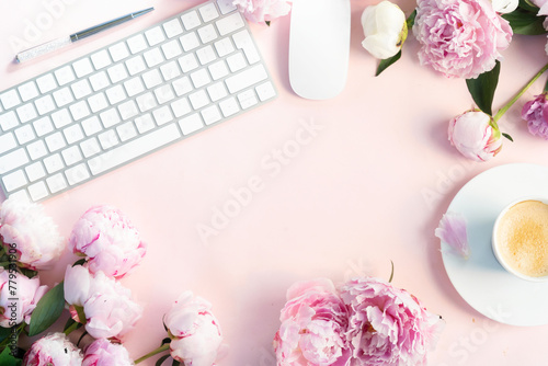 Beautiful fresh pink and white peony fresh flowers on pink table with cup of ...