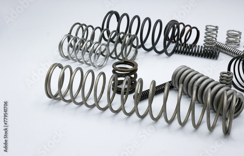 Metal springs of different shapes and sizes. White background. 