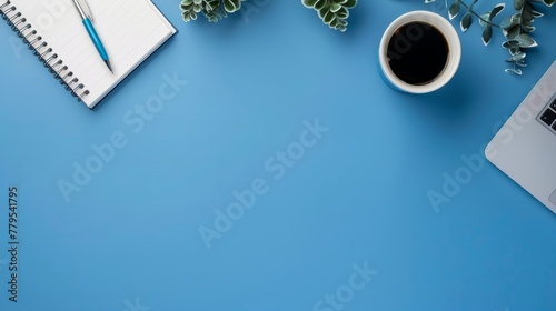 Minimal work space - Creative flat lay photo of workspace desk. Top view office desk with laptop, notebooks and coffee cup on blue color background. Panoramic banner background with copy space