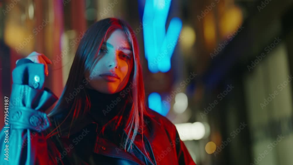 Beautiful woman posing for the camera against the background of the lights. Portrait luxury woman dusk street looking camera. Portrait of charming female. Fashionable lifestyle Beautiful woman posing for the camera against the background of the lights. Portrait luxury woman dusk street looking camera. Portrait of charming female. Fashionable lifestyle