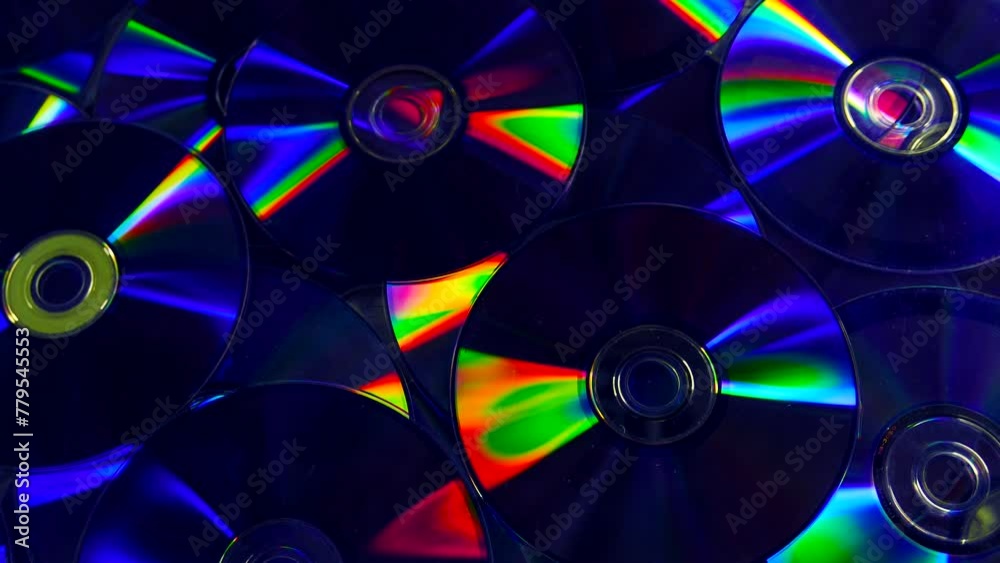 Closeup video of colorful dvd discs with iridescent highlights on the surface