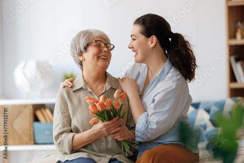 woman and her mother with flowers tulips