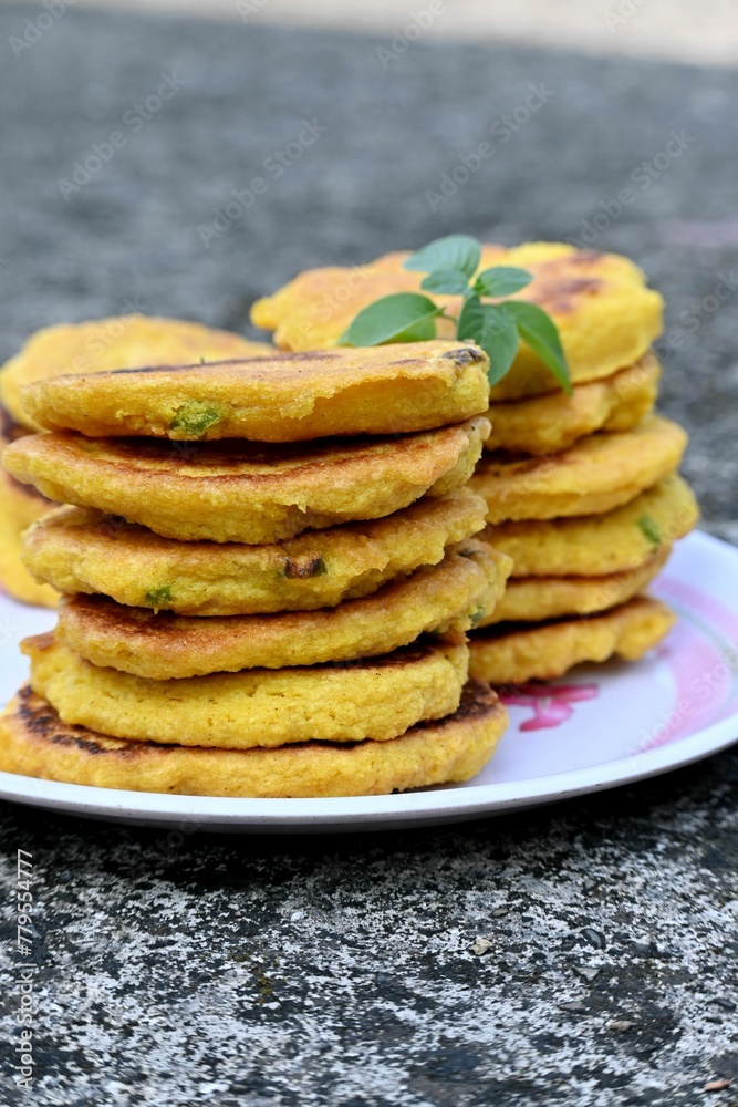Vertical shot of the homemade Potato pancakes put on the plate on blurred background