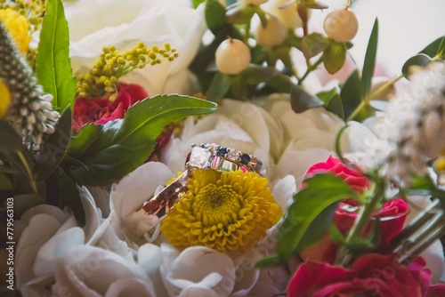Wedding rings on a flower in a beautiful bouquet photo