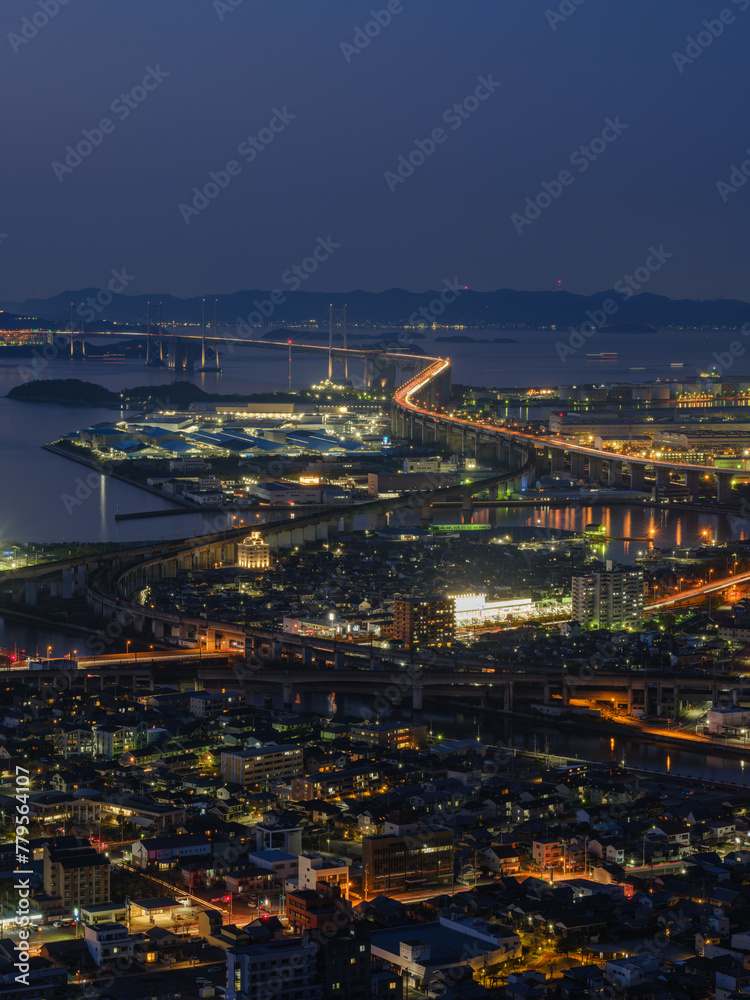 Beautiful top view of urban city with many buildings by the sea at night, Great Seto Bridge in Sakaide City in Kagawa Prefecture in Japan, Travel or outdoor, High resolution over 50MP