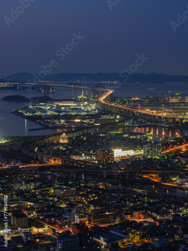 Beautiful top view of urban city with many buildings by the sea at night  Great Seto Bridge in Sakaide City in Kagawa Prefecture in Japan  Travel or outdoor  High resolution over 50MP