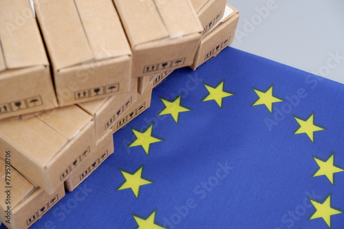 EU industry concept. European Union flag and many carton boxes.	