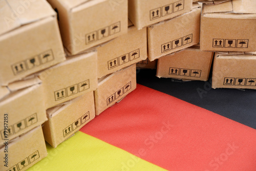 German export concept. Flag of Germany and many carton boxes close up.	