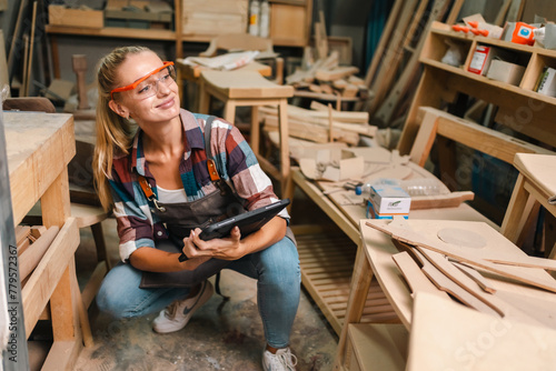 In a bustling carpenter's shop, a young woman craftsman expertly navigates her workshop, merging traditional woodwork skills with modern equipment to create hand-made furniture