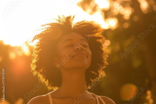 Young African American Woman Basking in the Warmth of Sunlight at Dusk
