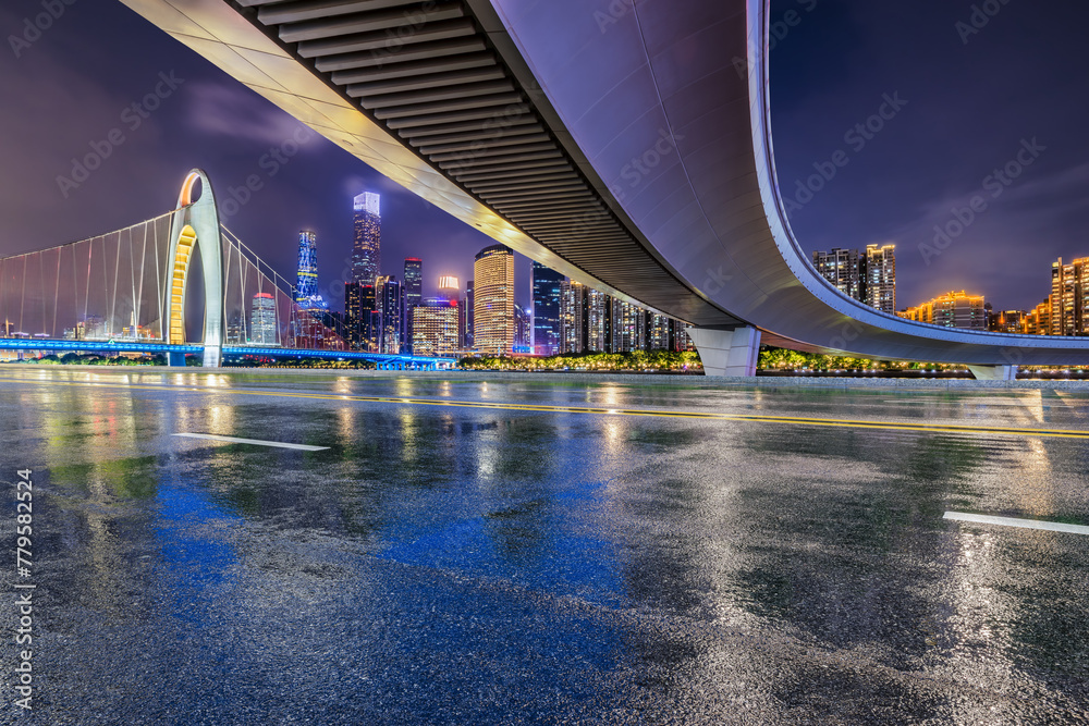 Asphalt road and bridge with modern city buildings scenery at night in Guangzhou. Road and city buildings background after rain. - obrazy, fototapety, plakaty 