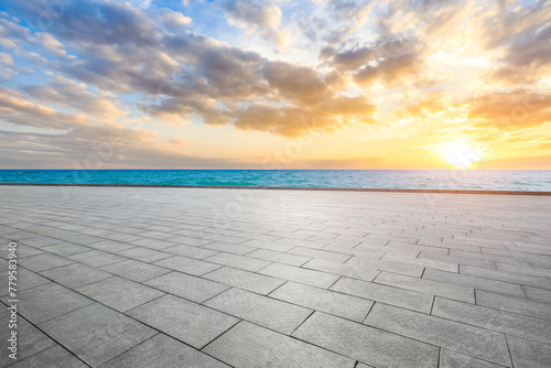 Empty square floor and clear lake water with sky clouds at sunset
