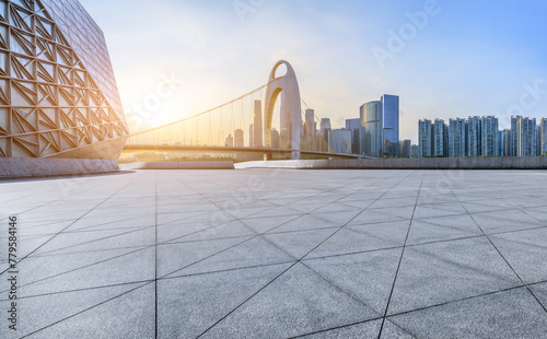 Empty square floors and city skyline with modern buildings at sunset in Guangzhou