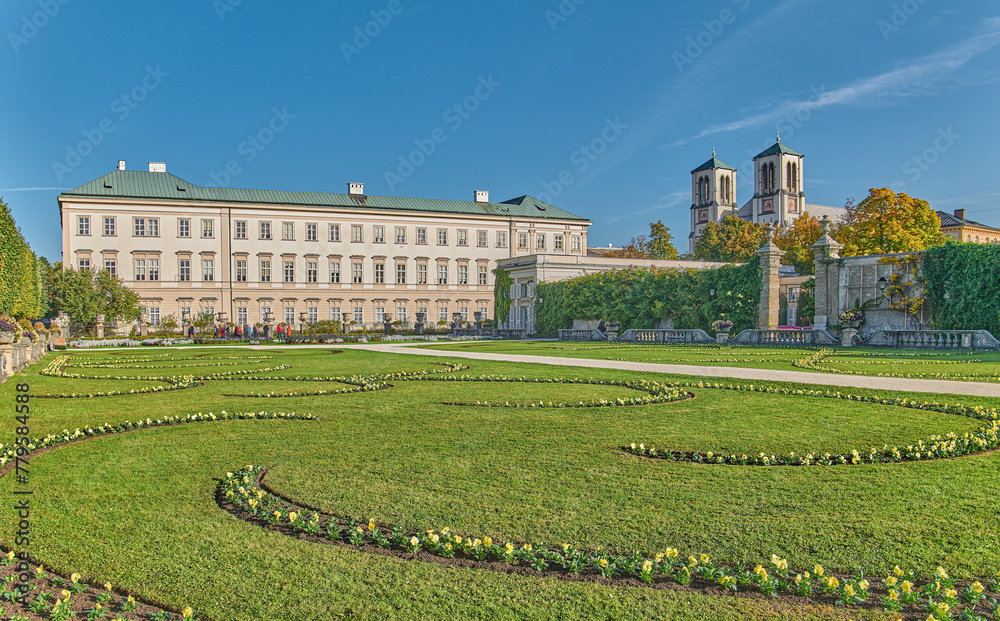 Salzburg, Austria -  October 6, 2022: The  Mirabell palace and garden with the St Andrew bell tower in the background