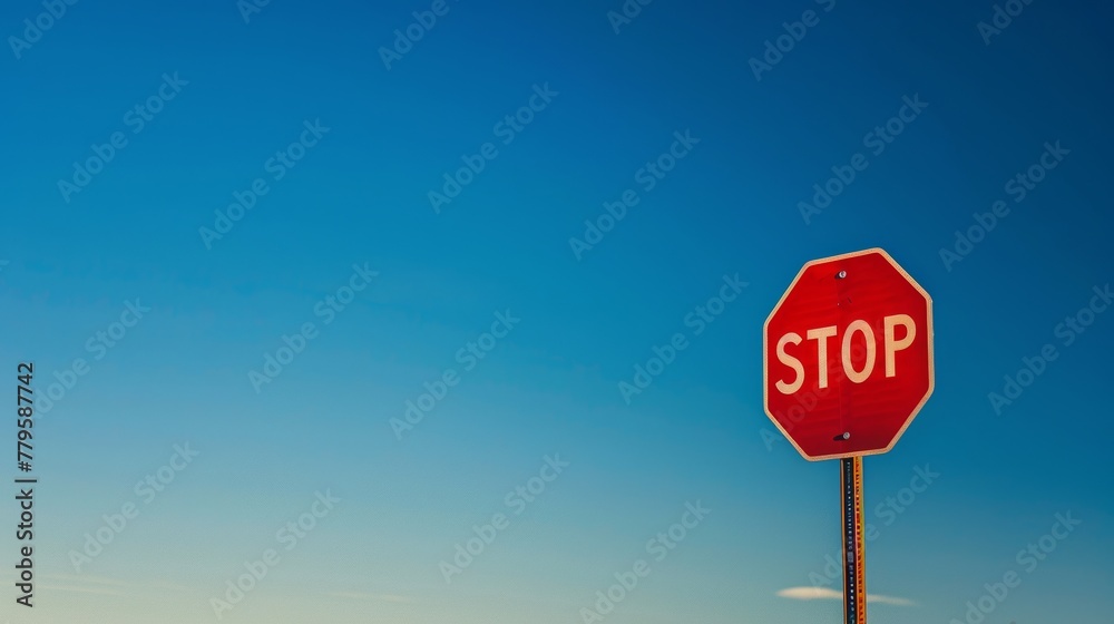 Vibrant stop sign against clear blue sky Vibrant stop sign against clear blue sky