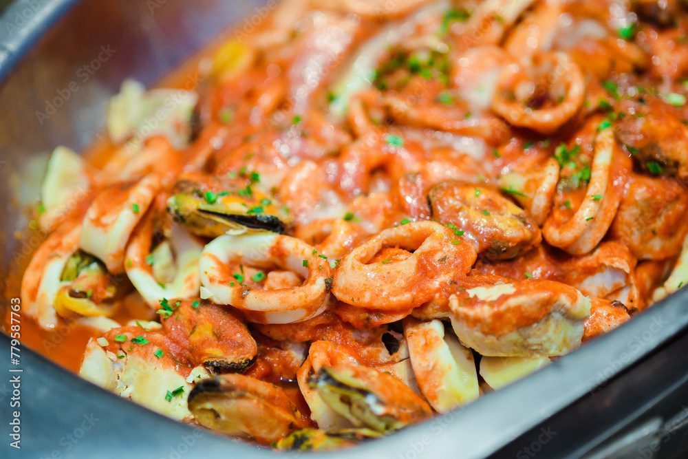 Closeup of Seafood Fra Diavolo in a metal container Closeup of Seafood Fra Diavolo in a metal container