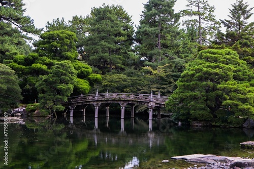 Bridge over a lake in Imperial Palace surrounded by trees in Kyoto, Japan