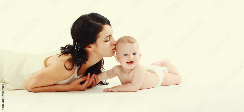 happy young mother playing with baby lying on the floor happy young mother playing with baby lying on the floor