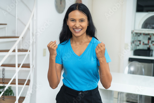 Happy cheering young mexican woman with casual clothes