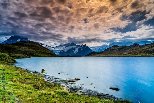 Gorgeous view of lake Bachalpsee in Grindelwald, Switzerland under a beautiful cloudy sky photo