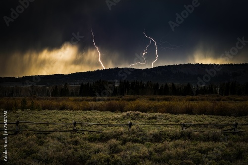 Photography Mesmerizing lightning storm over the green field in Jackson Hole