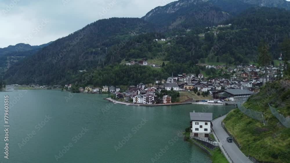 Drone shot of Lake Alleghe in Belluno, Dolomites, Italy Drone shot of Lake Alleghe in Belluno, Dolomites, Italy