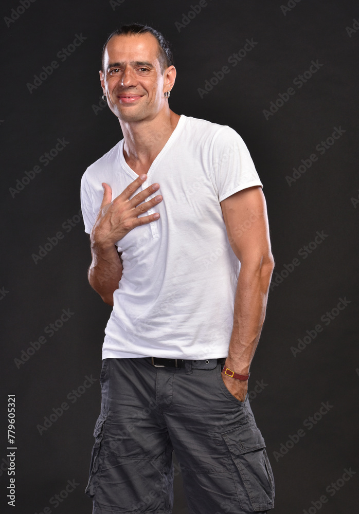 Handsome man in white T-shirt posing in studio