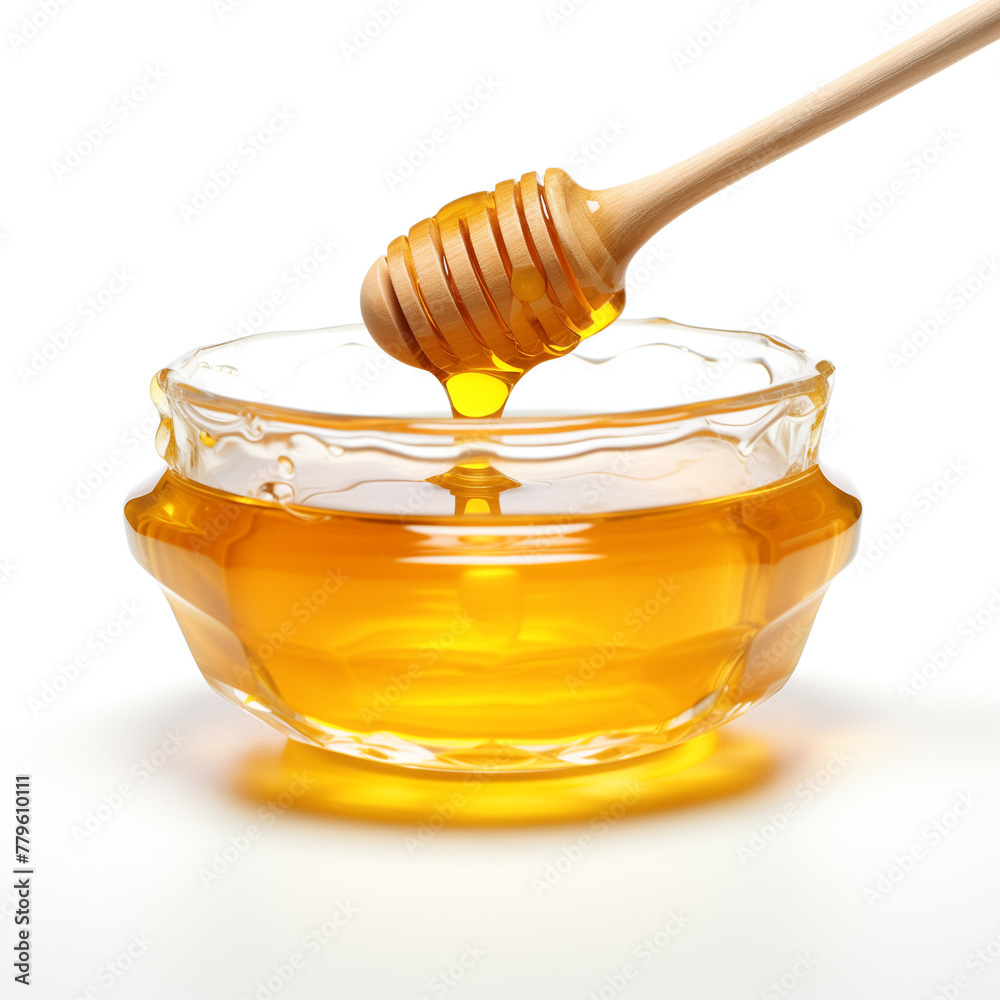 Golden honey dripping from dipper into jar Golden honey dripping from dipper into jar