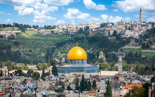 Panoramic view of the old city of Jerusalem, Dome of the Rock in the center, Mount of Olives in the background. blue sky with clouds. Jerusalem, Israel April 8, 2024 © Marcio