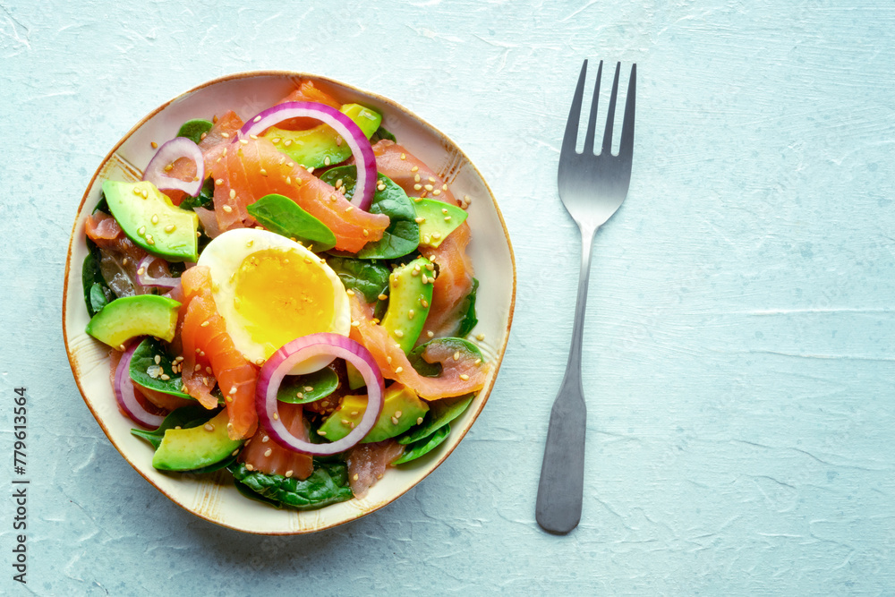 Salmon, avocado and egg salad with fresh leaves and onions, overhead flat lay shot on a slate background. Healthy diet, with copy space Salmon, avocado and egg salad with fresh leaves and onions, overhead flat lay shot on a slate background. Healthy diet, with copy space