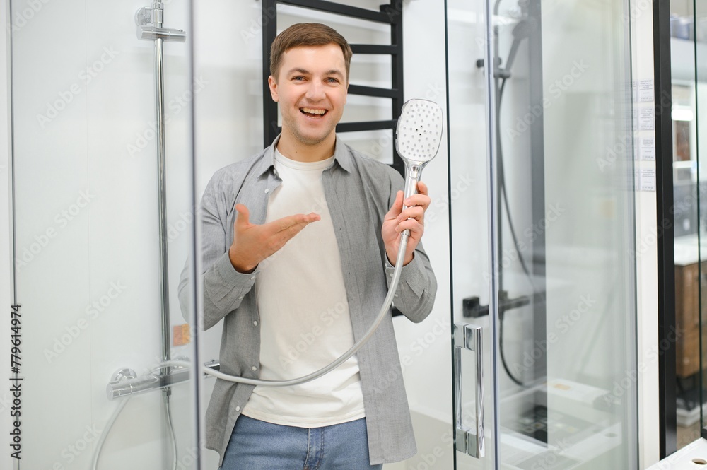 man choosing shower cabin and utensils for his home bathroom man choosing shower cabin and utensils for his home bathroom