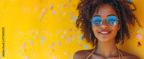 Banner of young curly hair black american woman in blue sunglasses on yellow background. Concept of summer holidays. Protecting eyes from sunlight and ultraviolet rays photo