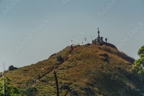 A group of people are walking up a hill