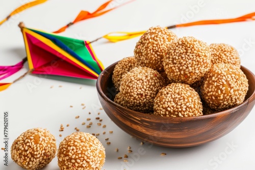 Indian festival concept sesame seed ball colorful paper kite on white background photo