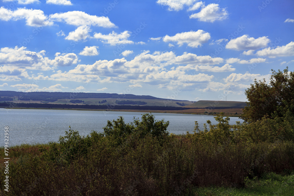 landscape. The largest lake. Blue sky with beautiful clouds. park in summer. Blue water in the river. Dense forest.Sandy beach.
landscape. The largest lake. Blue sky with beautiful clouds. park in summer. Blue water in the river. Dense forest.Sandy beach.