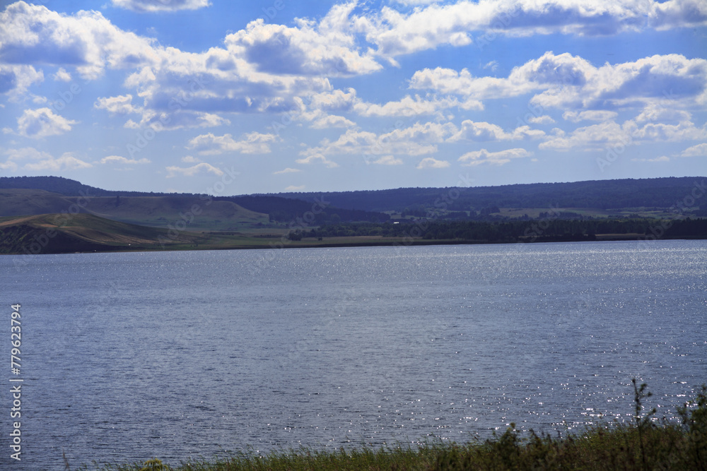 andscape. The largest lake. Blue sky with beautiful clouds. park in summer. Blue water in the river.	
