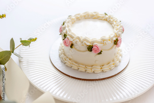 Festive bento cake and bouquet on a light background