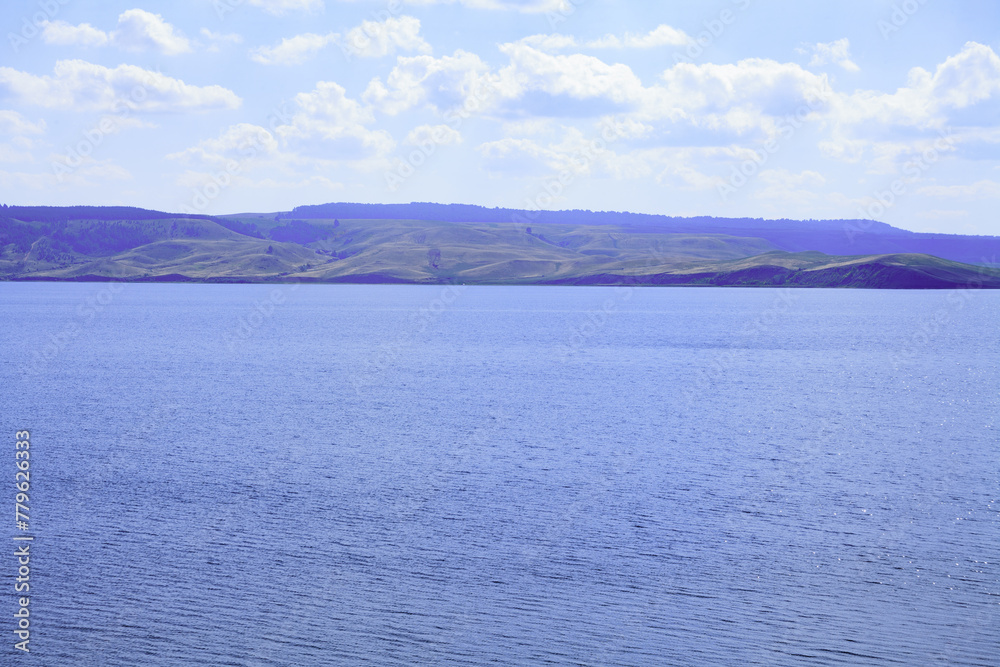 andscape. The largest lake. Blue sky with beautiful clouds. park in summer. Blue water in the river.	