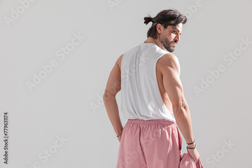 back view of fit man showing arm muscles and looking to side