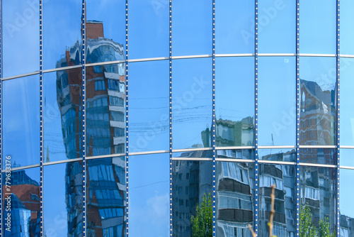 Buildings of modern architecture reflect each other in mirror walls. Architectural concept of urbanism.