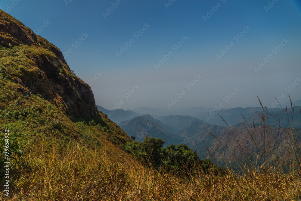 A mountain range with a clear blue sky in the background