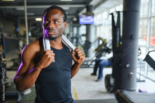 Thoughtful young man with towel in health club