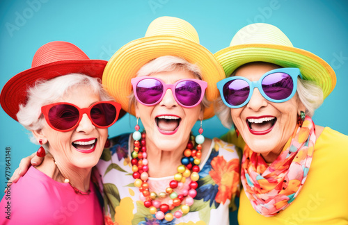 Outdoor portrait of females old aged friends together with sunglasses having fun. Group of mature women friends posing for a photo in summer outdoor in a leisure activity. Forever young concept.  © Victor