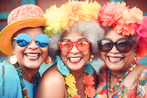 Outdoor portrait of females old aged friends together with sunglasses having fun. Group of mature women friends posing for a photo in summer outdoor in a leisure activity. Forever young concept. 