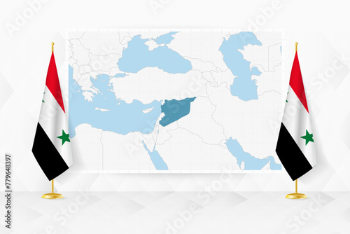 Map of Syria and flags of Syria on flag stand.