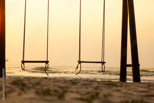 Swing at the white beach evening light atmosphere