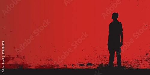 A man stands in front of a red background